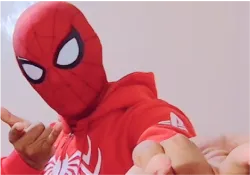 A person in a spider man costume pointing at something